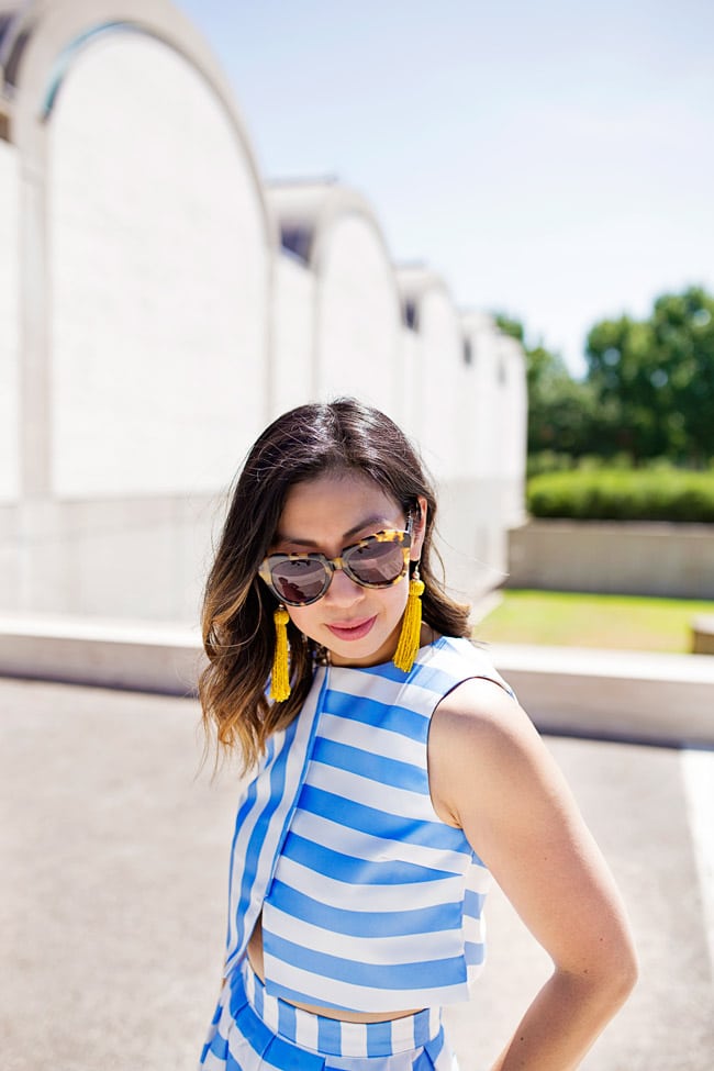 blue striped crop top and midi skirt matched set coordinates, yellow tassel earrings, retro modern style, how to wear a midi skirt, karen walker number one sunglasses