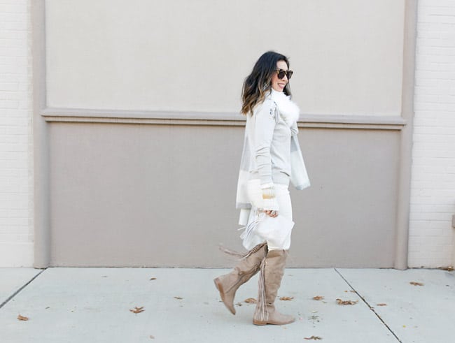 winter neutral outfit, how to wear a faux fur scarf, fingerless gloves, tassel riding boots