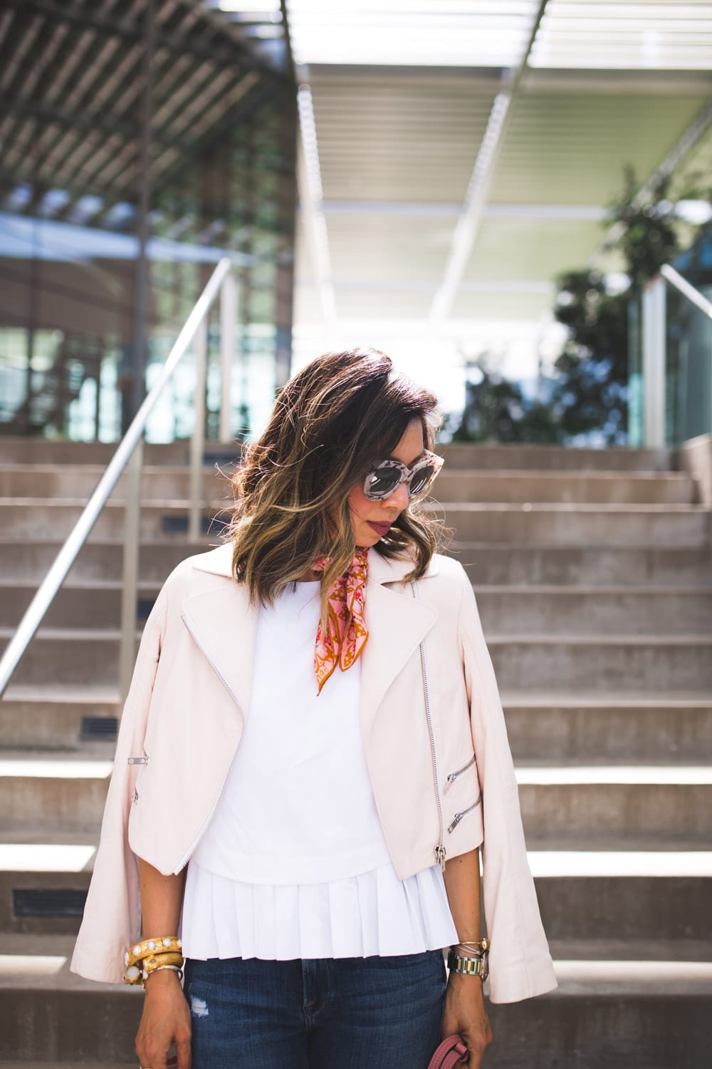quay sugar and spice sunglasses, cuyana pleated top, rag and bone pink moto jacket