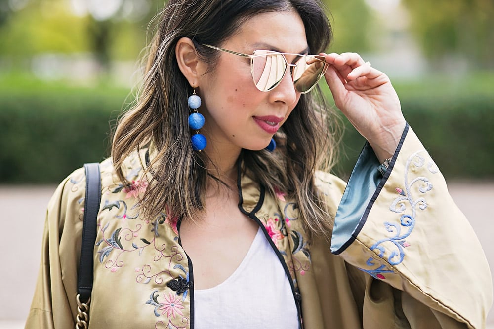 rose gold reflective sunglasses, blue circle drop earrings, gold embroidered asian robe with white tank and levi's mom jeans