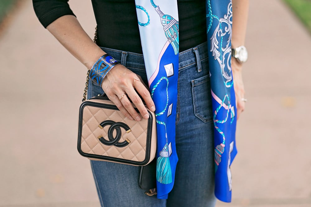 blue hermes maxi twilly with black top, flare jeans, and chanel filigree vanity bag