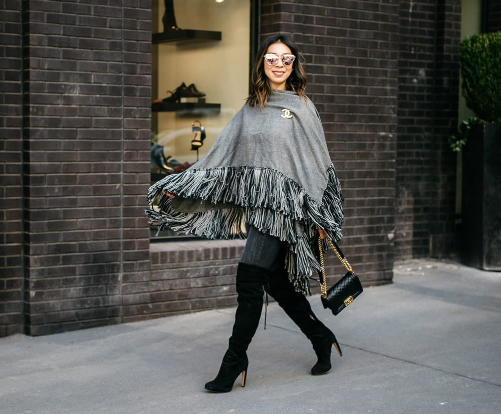 who what wear grey fringe poncho with black otk boots, chanel brooch and boy bag