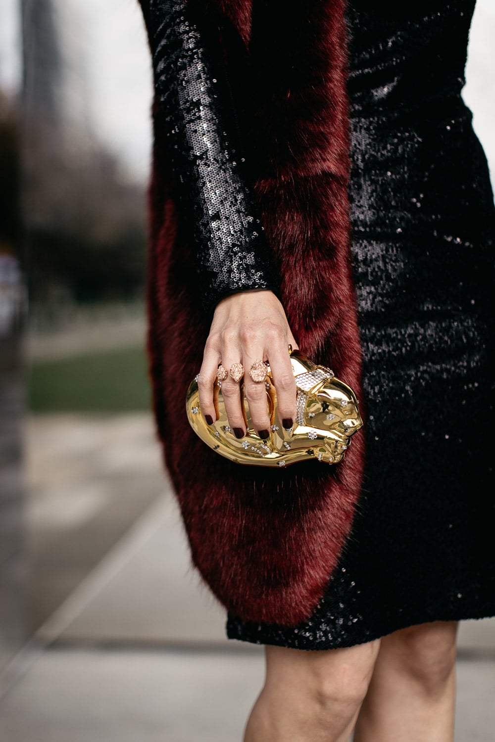 black sequin dress with burgundy fur stole and kendra scott druzy double ring