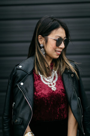 easy holiday outfit, burgundy velvet bodysuit and moto jacket, T+J design statement necklace, sachin and babi grape earrings