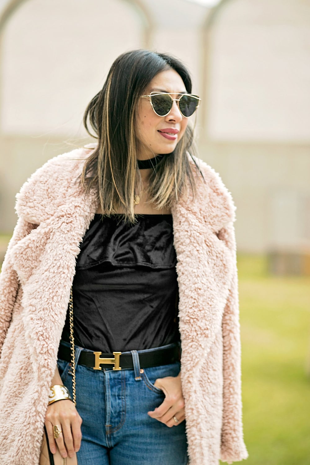 modern way to wear a monogram necklace with a choker, tularosa pink fur coat, hermes belt on high waisted jeans