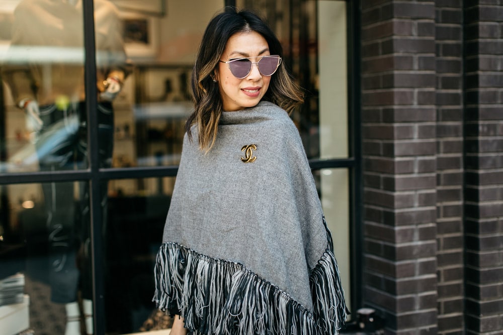 who what wear grey fringe poncho pinned with chanel cc brooch