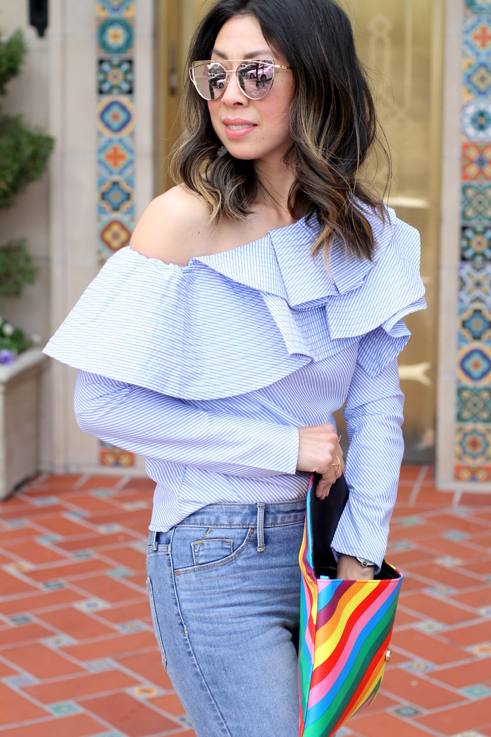 stylekeepers ruffle one shoulder top with ripped knee skinny jeans and rainbow clutch, pink pumps