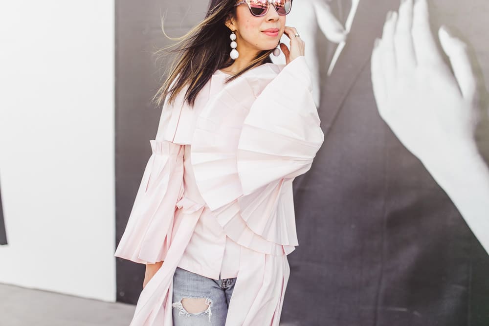 charles youssef pink pleated tunic top with boyfriend jeans and baublebar white crispin drop earrings
