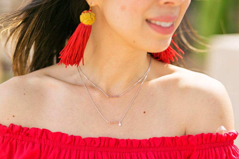 vanessa mooney red tassel earrings, off the shoulder top, fossil hello love necklace