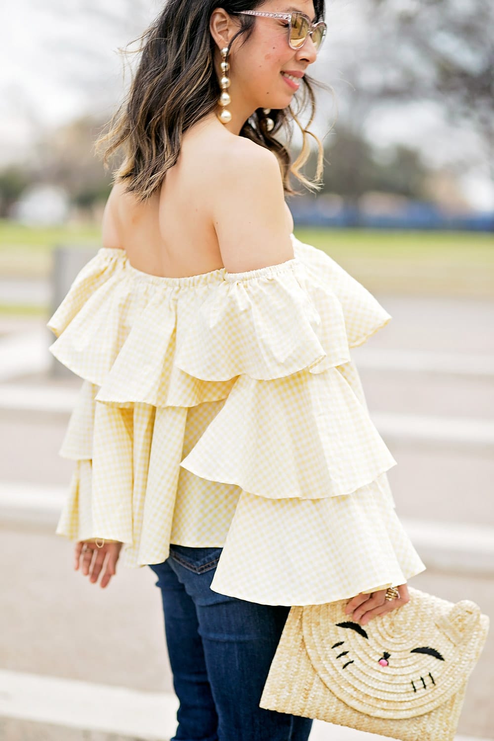 beehive fort worth off the shoulder gingham ruffle top and pearl drop statement earrings with happy cat straw clutch