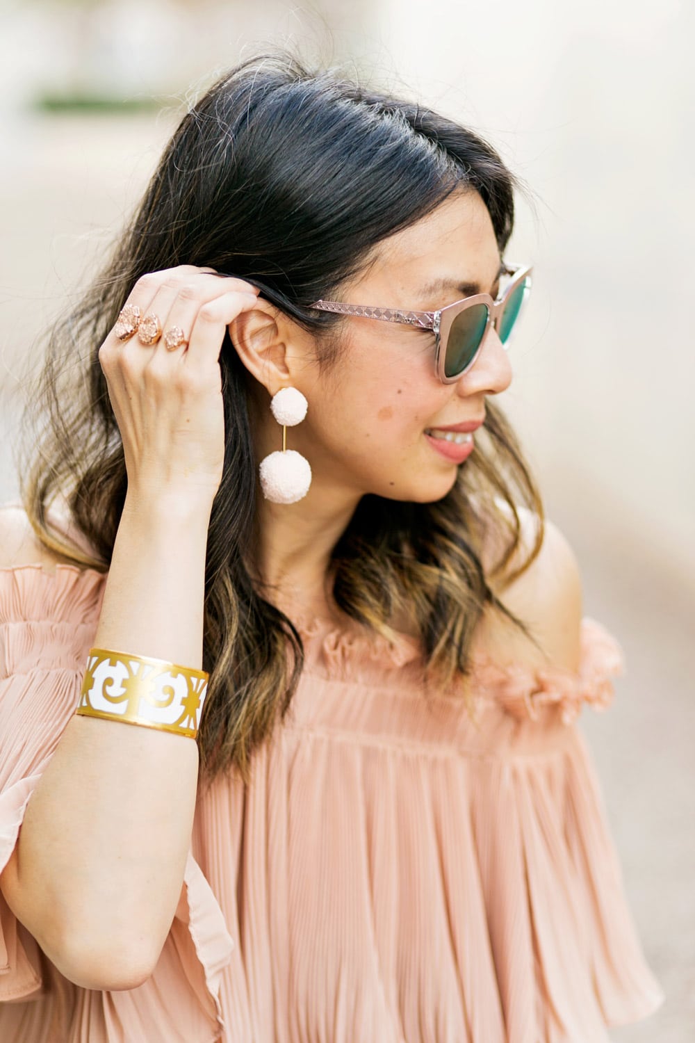 baublebar bahama pink pom pm earrings with endless rose pink pleated off the shoulder top and hermes balcones bangle, dior diorama pink mirrored sunglasses, spring outfit idea 