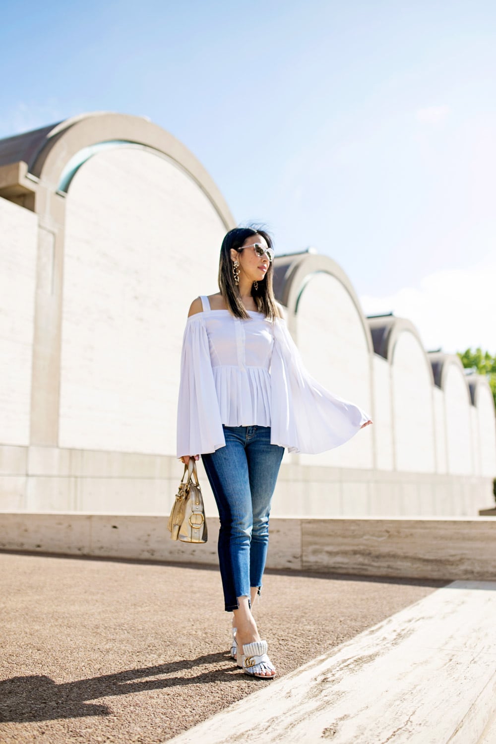 charles youssef pleated off the shoulder top with lele sadoughi windchime earrings and whbm tuxedo jeans, gucci marmont silver loafers, ysl mini muse gold