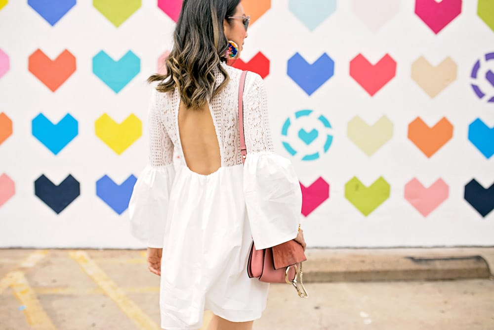 endless rose lace bell sleeve dress with pom pom earrings and pink chloe faye bag at liketoknow.it heart wall in dallas
