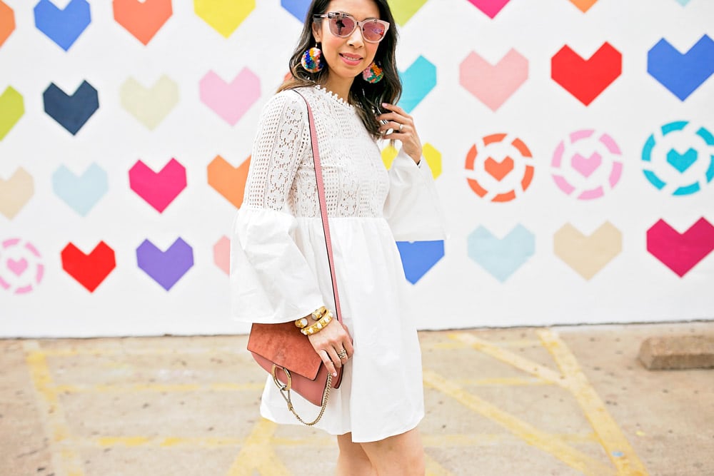 endless rose lace bell sleeve dress with pom pom earrings and pink chloe faye bag at liketoknow.it heart wall in dallas