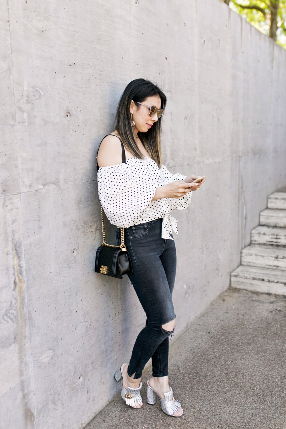 polka dot puff sleeve off the shoulder top with lele sadoughi plumeria drop earrings, rag and bone slit capri jeans in steel, gucci silver marmont mules and chanel boy bag