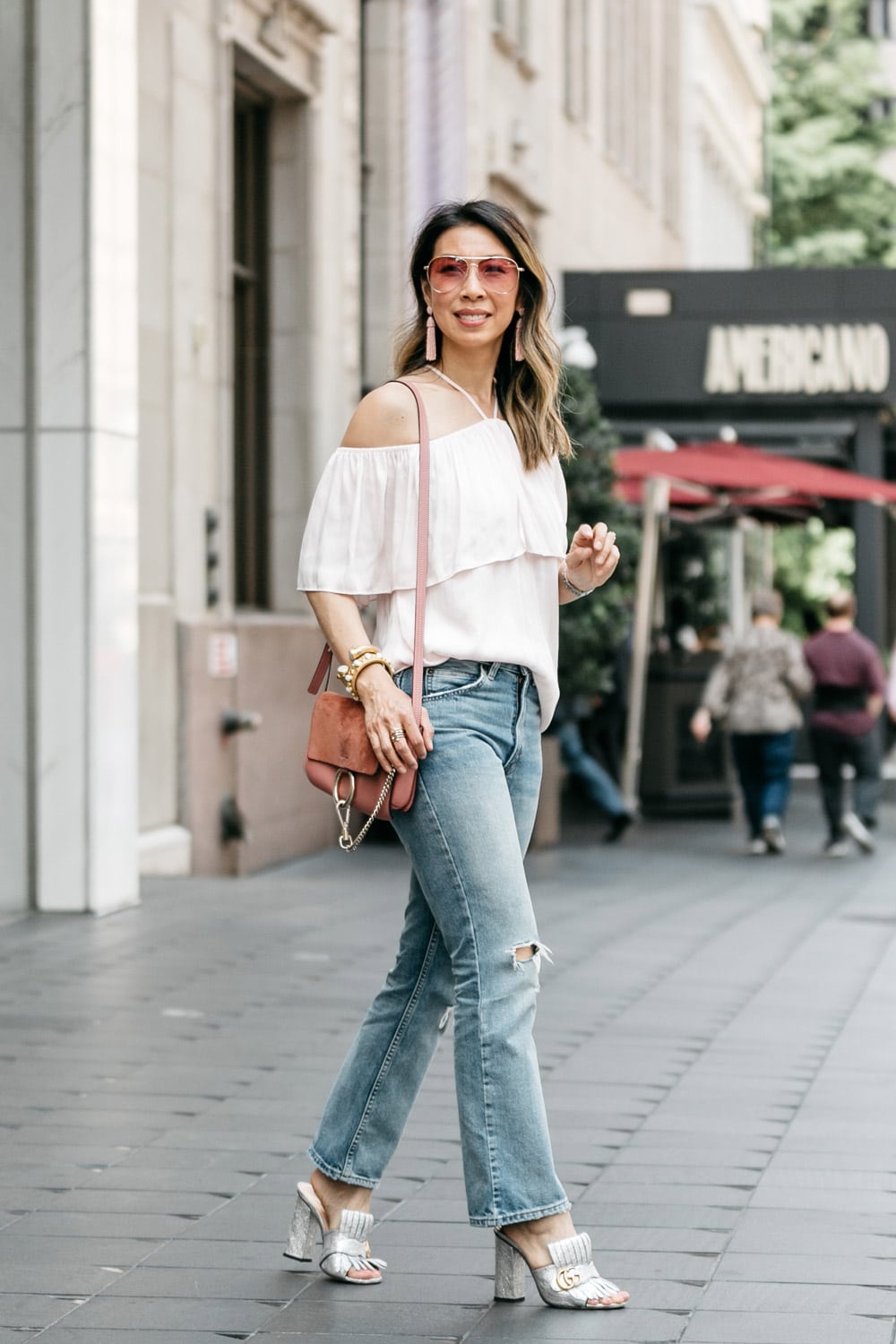 ruffle halter off the shoulder top with levi's 517 cropped flares and gucci silver marmont slides, rose pink chloe faye, bauble bar pinata tassel earrings, sonix rose pink aviator sunglasses
