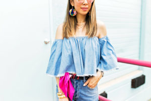 how to wear double denim off the shoulder frayed top DSTLD distressed mom jeans pom pom earrings