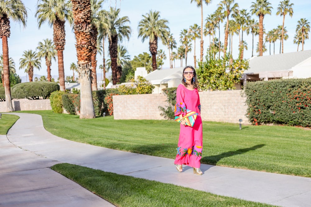pink bell sleeve embroidered dress and rainbow clutch in palm springs california