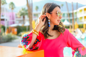 pink bell sleeve embroidered dress, blue ball drop earrings, julie vos bracelet stack in palm springs california