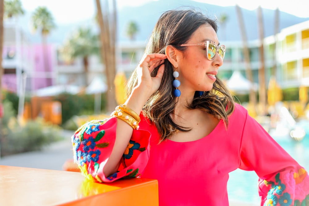 pink bell sleeve embroidered dress, blue ball drop earrings, julie vos bracelet stack in palm springs california