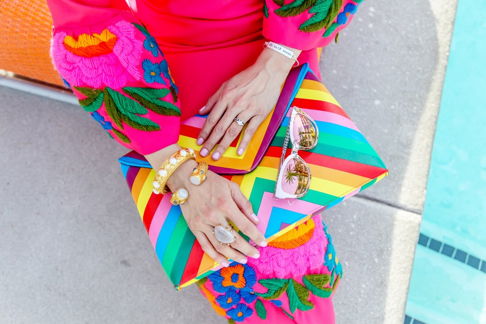 pink bell sleeve embroidered dress and rainbow clutch, dior diorama sunglasses, julie vos bracelet stack, kelly wearstler tamarindo ring