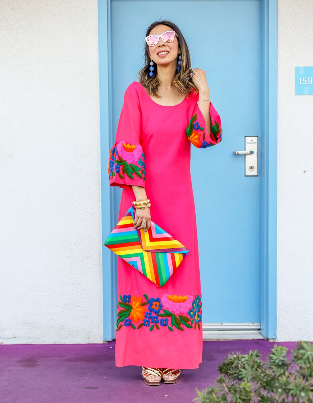 pink bell sleeve embroidered dress and rainbow clutch in palm springs california