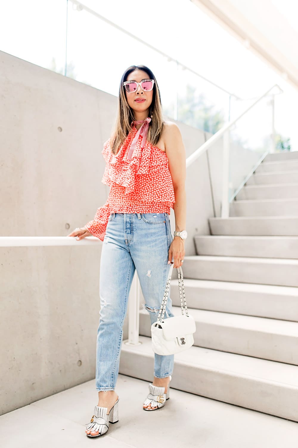 rosie assoulin corkscrew one shoulder ruffle top dupe levi's wedgie jeans gucci silver mules chanel white flap dior diorama cage sunglasses