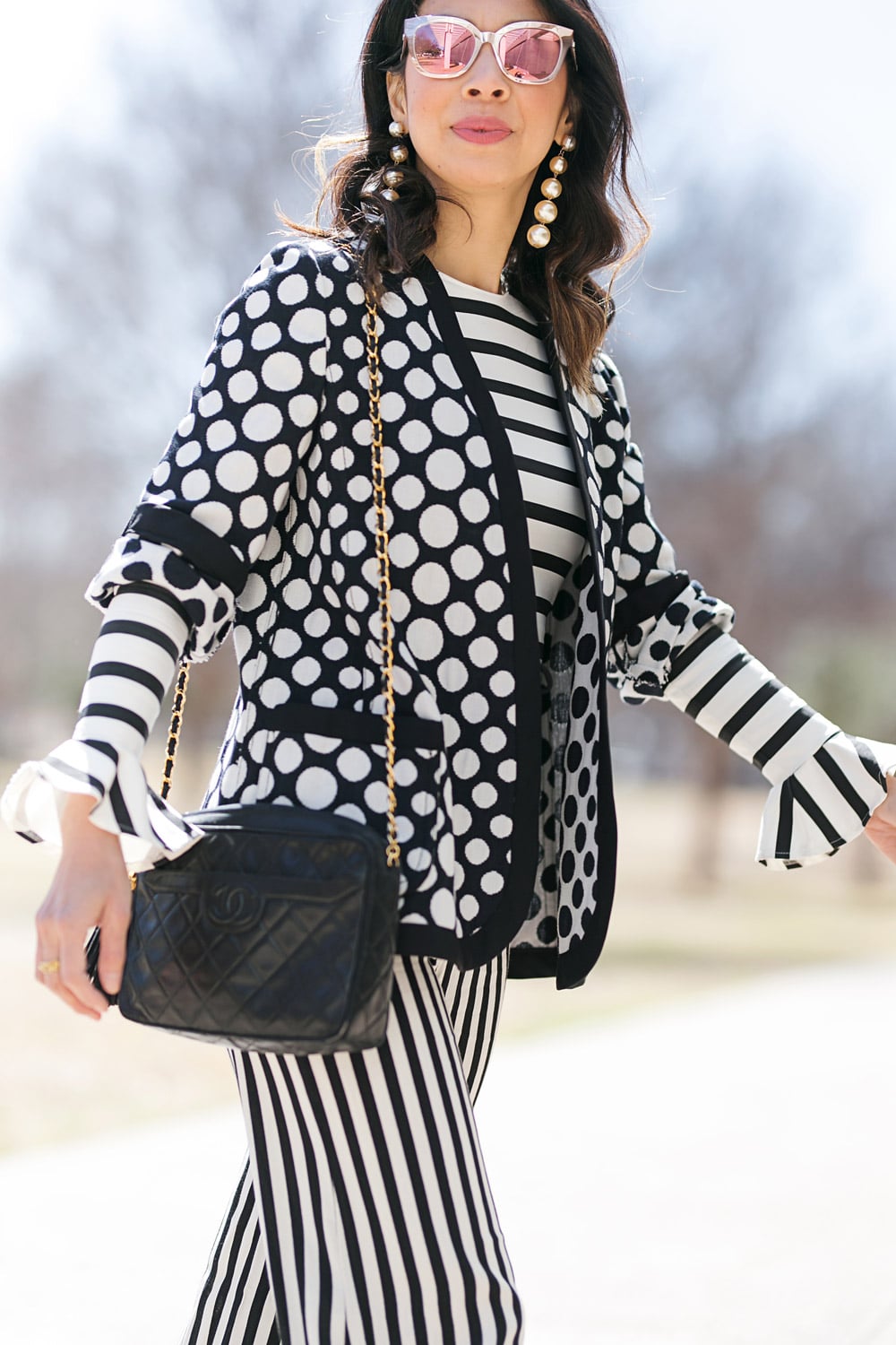 style of sam in polka dot jacket with chanel camera bag
