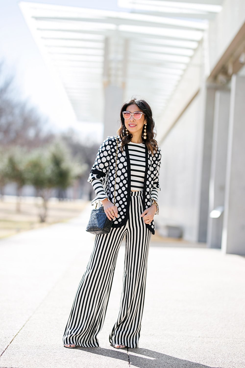 style of sam in polka dot jacket and reformation striped pants