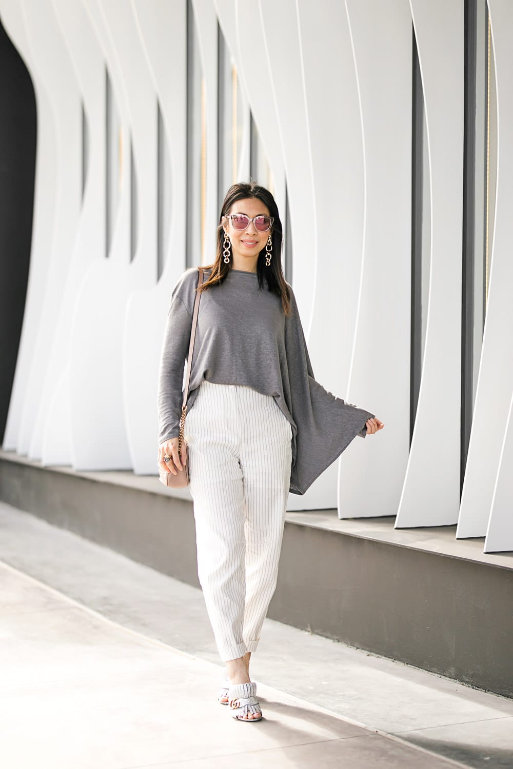 style of sam in ruti asymmetrical top and pinstripe pants