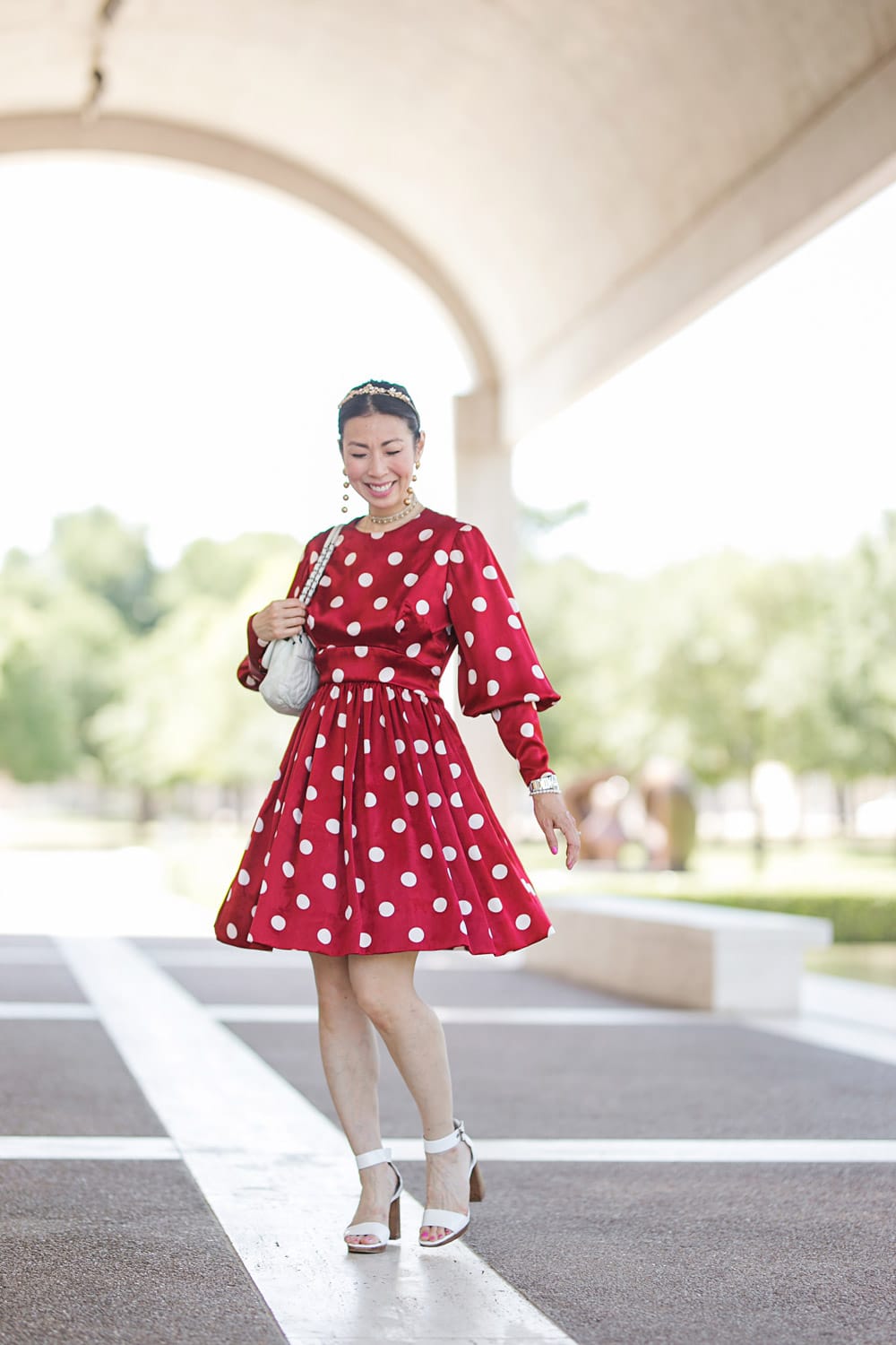 style of sam in red polka dot dress twirling