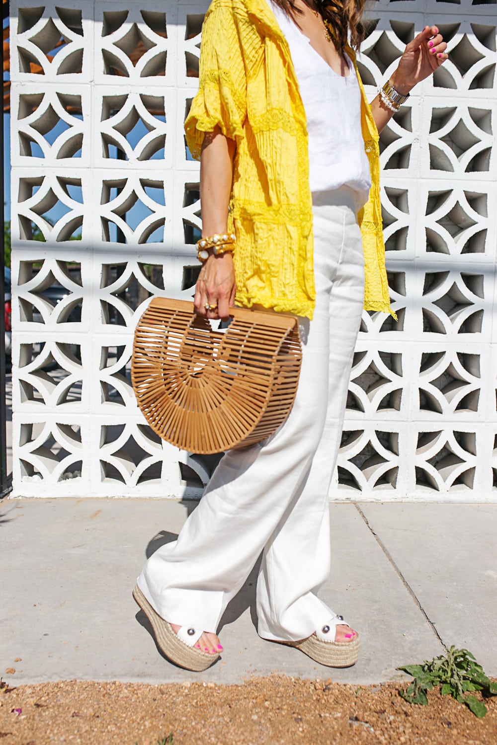 style of sam in yellow cardigan white linen pants bamboo arc bag