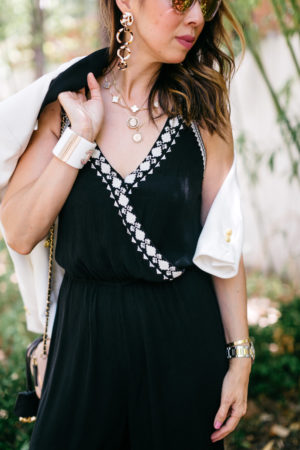 style of sam in black jumpsuit with veronica beard white jack blazer and van cleef and arpels alhambra necklace details