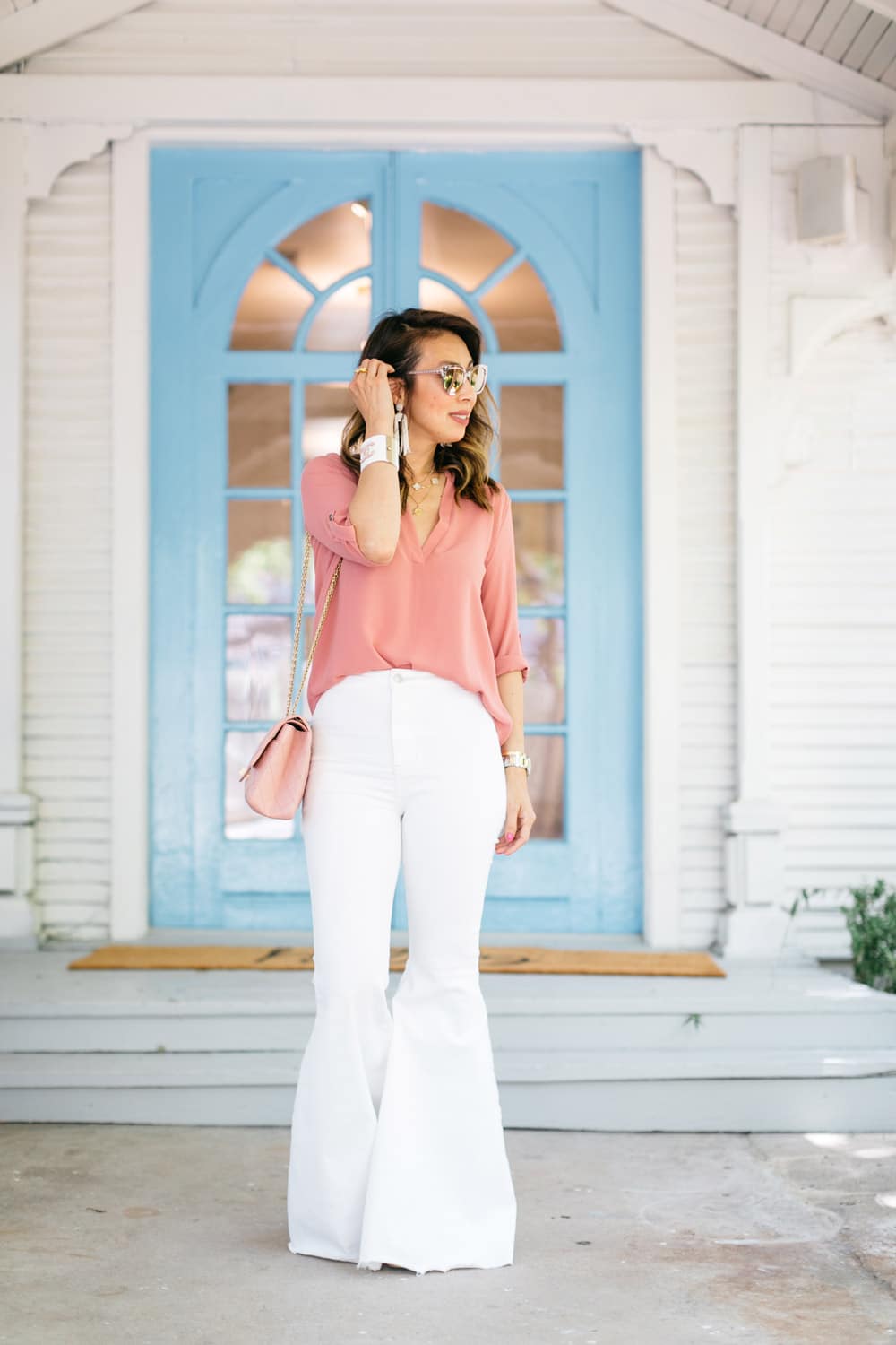style of sam dallas blogger in pink tunic top free people white flare jeans pink chanel reissue flap