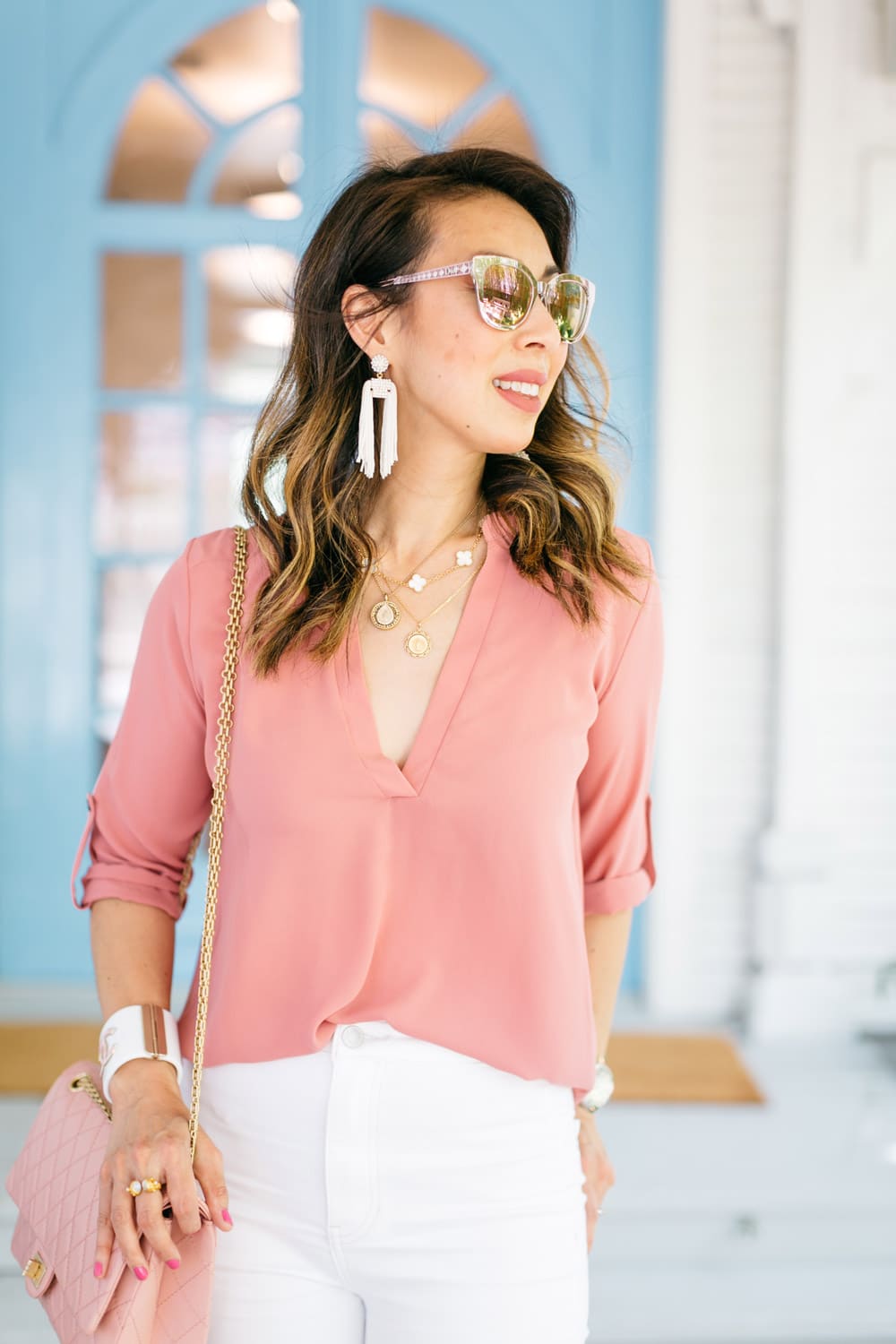 style of sam dallas blogger in pink tunic top white tassel earrings vca alhambra necklace