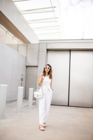 fort worth blogger in white jumpsuit chanel turnlock necklace earrings white flap