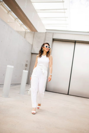 fort worth blogger in white jumpsuit chanel turnlock necklace earrings white flap