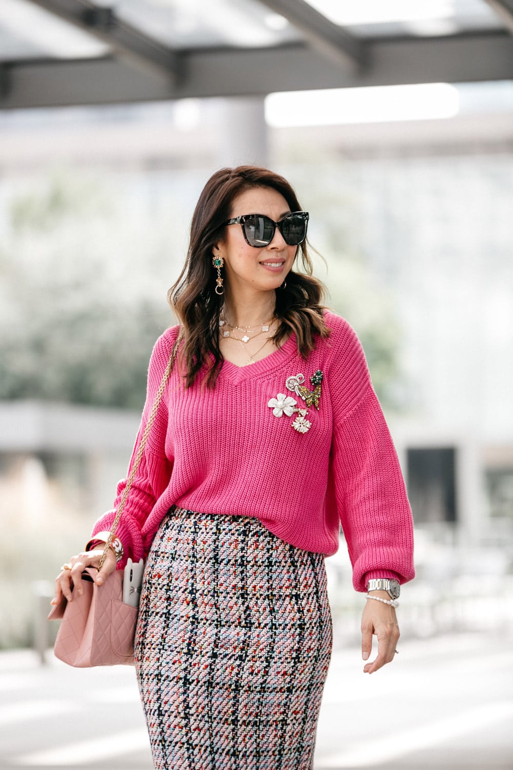 style of sam in pink v-neck sweater tweed skirt pinned vintage brooches chanel reissue