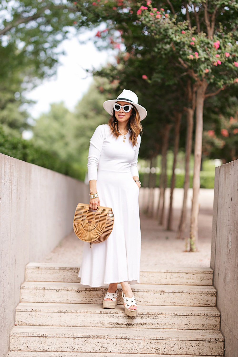 style of sam in white midi dress fedora hat bamboo arc bag in summer transition for fall