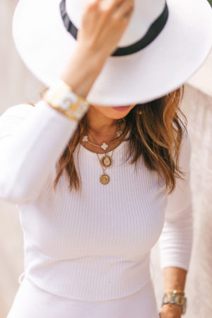 style of sam in white midi dress van cleef and arpels alhambra necklace mustard seed jewelry opal necklace miraculous mary necklace