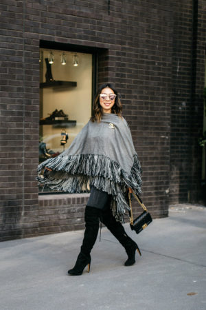 style of sam in grey black fringe poncho with chanel brooch