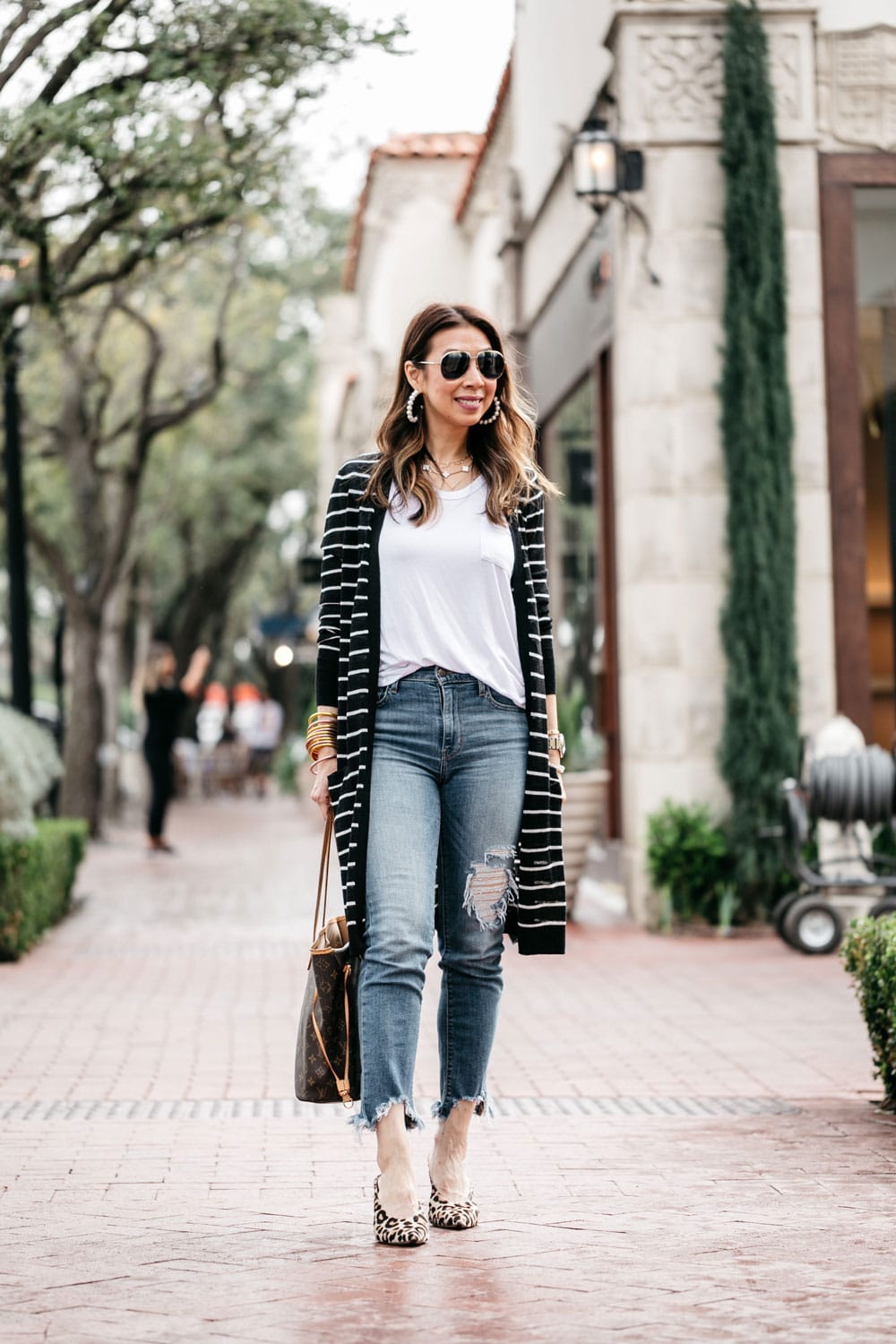 style of sam in long linen striped cardigan, white tee, levi's cropped raw hem jeans leopard mules, lv neverfull mm