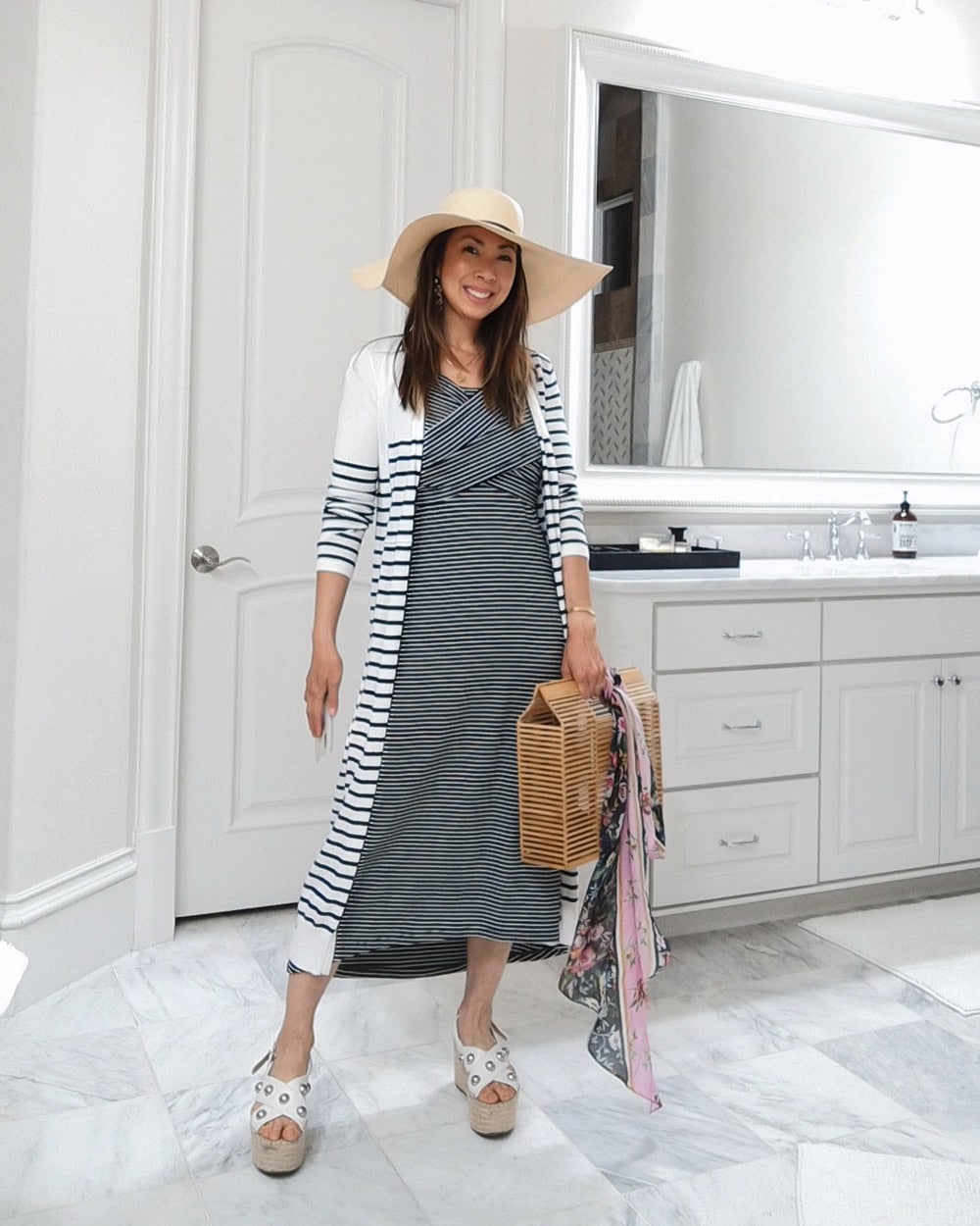 style of sam in cabi navy and white striped launch dress, cha cha earrings, long striped cardigan, flaunt floral scarf tied to bamboo bag, white espadrilles