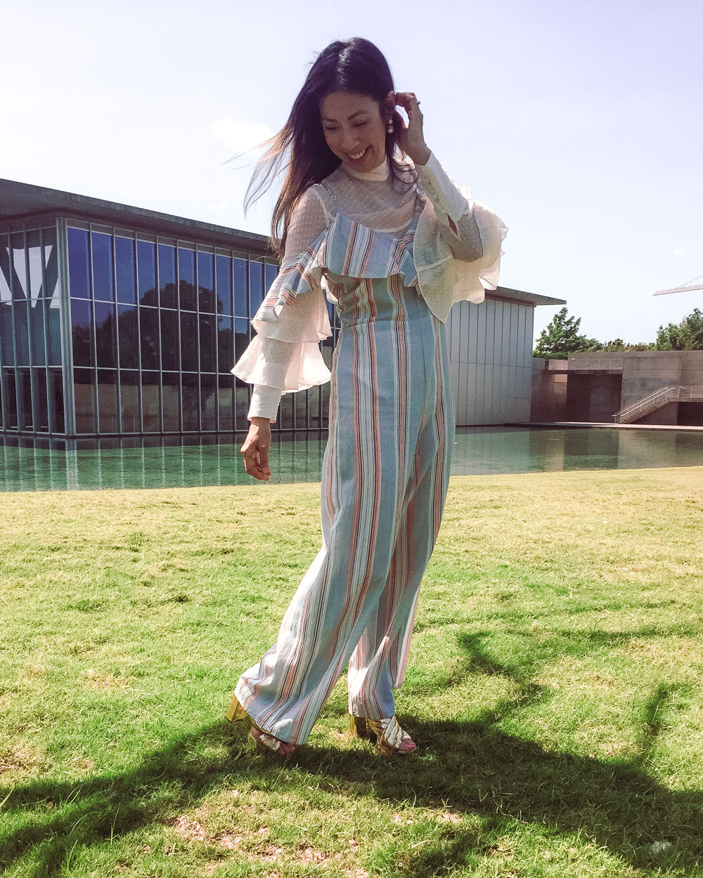 style of sam in striped jumpsuit with ruffle top at modern museum fort worth