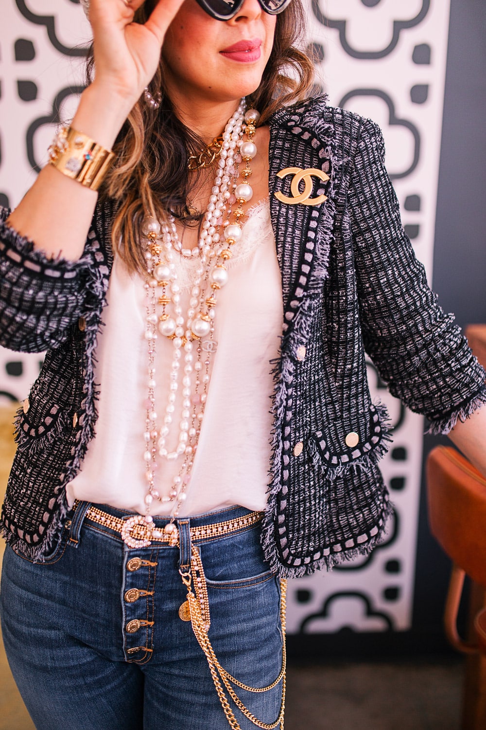 style of sam in misook tweed jacket, chanel brooch and pearl necklaces, veronica beard jeans with chains and rhinestone belt