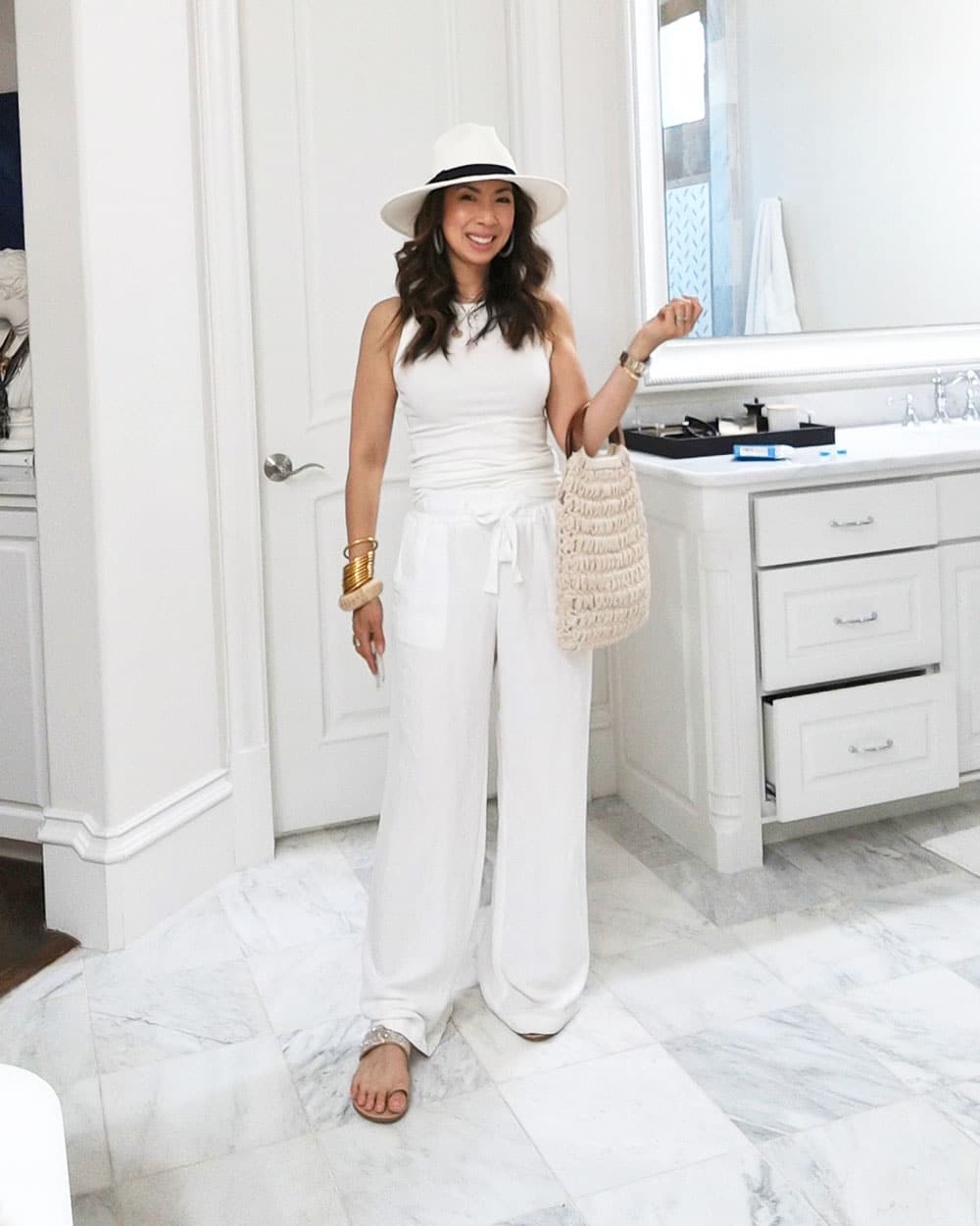 style of sam in white target tank top, linen pants, and hat