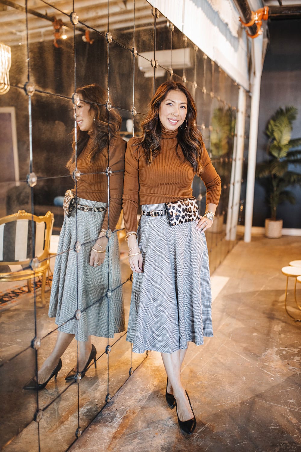 style of sam in brown turtleneck and plaid metallic midi skirt