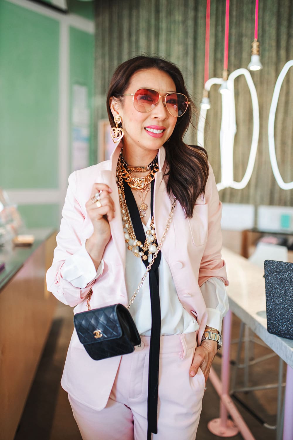 style of sam in cabi pink grace blazer & trouser over accessorized with chanel