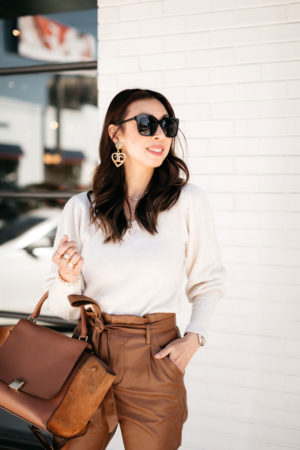style of sam in vintage chanel heart earrings, puff sleeve top, celine trapeze bag
