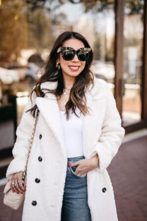 style of sam in winter white coat and linda farrow dunaway sunglasses